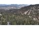 Lush forest landscape rolling to meet scenic mountain views at 5525 S Twin Spruce Dr, Evergreen, CO 80439