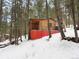 Charming cabin with a covered porch, surrounded by mature trees and a snowy landscape at 5525 S Twin Spruce Dr, Evergreen, CO 80439