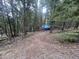 Property with buildings covered by blue tarps in the forest at 5525 S Twin Spruce Dr, Evergreen, CO 80439