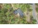 Aerial view of a home with a hot tub, surrounded by lush forest and a winding driveway at 1150 Fremont Dr, Larkspur, CO 80118