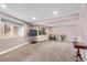 This finished basement has neutral paint and carpet, recessed lighting, and natural light from the two windows at 1150 Fremont Dr, Larkspur, CO 80118