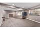 This finished basement has neutral paint and carpet, recessed lighting, and natural light from the window at 1150 Fremont Dr, Larkspur, CO 80118