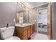 Bathroom features include a double sink vanity, large mirror, and natural lighting at 1150 Fremont Dr, Larkspur, CO 80118