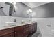 This bathroom has a double vanity with white porcelain sinks and a gray accent wall at 1150 Fremont Dr, Larkspur, CO 80118