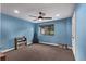 This bedroom features a ceiling fan, a window to let natural light in, and blue walls at 1150 Fremont Dr, Larkspur, CO 80118