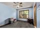 This bedroom features a ceiling fan, a window to let natural light in, and blue walls at 1150 Fremont Dr, Larkspur, CO 80118