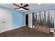 This bedroom features a ceiling fan, an open doorway, and blue walls at 1150 Fremont Dr, Larkspur, CO 80118