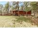 Beautiful home with a wood exterior, stone accents, an inviting deck, and a well-maintained lawn at 1150 Fremont Dr, Larkspur, CO 80118