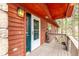 Inviting front porch featuring wood accents, a sturdy railing, and a charming entry door with ample light at 1150 Fremont Dr, Larkspur, CO 80118