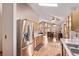 Spacious kitchen with stainless steel refrigerator, wood cabinets, hardwood floors, and dining area view at 1150 Fremont Dr, Larkspur, CO 80118