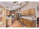 Bright kitchen with wood cabinets, stainless steel appliances, and hardwood floors with ample counter space at 1150 Fremont Dr, Larkspur, CO 80118