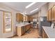 Well-lit kitchen with wood cabinets, stainless steel appliances, hardwood floors, and a garden view at 1150 Fremont Dr, Larkspur, CO 80118