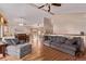 Open-concept living area featuring hardwood floors, vaulted ceilings, and a comfortable gray sofa set at 1150 Fremont Dr, Larkspur, CO 80118