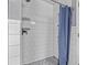 This shower features subway tile, a shower curtain, and unique floor tiles at 1150 Fremont Dr, Larkspur, CO 80118