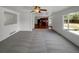 Bright, open-concept living room featuring a ceiling fan and large windows for natural light at 12550 Eastlake Dr, Thornton, CO 80241