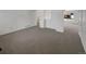 Spacious living area with neutral carpeting, offering ample room for flexible design and natural light at 12550 Eastlake Dr, Thornton, CO 80241