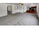 Bright living room with an open floor plan, neutral carpet, and an opening looking into another room at 12550 Eastlake Dr, Thornton, CO 80241