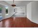 An open floor plan, featuring hardwood flooring, a ceiling fan and outdoor views from the dining area at 12550 Eastlake Dr, Thornton, CO 80241