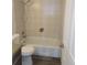 Bright bathroom with a shower-tub combination and neutral tile at 230 S 22Nd Ave, Brighton, CO 80601