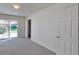 Well-lit bedroom featuring neutral carpet, closet, and sliding glass door at 230 S 22Nd Ave, Brighton, CO 80601