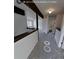 Neutral hallway with decorative wooden beam accents and views of other rooms at 230 S 22Nd Ave, Brighton, CO 80601
