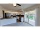 Updated kitchen features stainless appliances, white cabinets, dark backsplash, and access to the patio at 230 S 22Nd Ave, Brighton, CO 80601