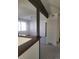 Open-concept living room featuring dark wood decorative beams and neutral carpeting at 230 S 22Nd Ave, Brighton, CO 80601