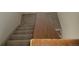 View looking down the carpeted staircase and hardwood trim at 230 S 22Nd Ave, Brighton, CO 80601