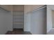 Spacious walk-in closet features shelving, closet rod, and white walls at 230 S 22Nd Ave, Brighton, CO 80601