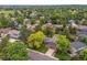 Aerial view of a house with a large yard surrounded by mature trees at 8268 W Caley Pl, Littleton, CO 80123