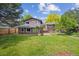 Large backyard with mature trees and expansive lawn at 8268 W Caley Pl, Littleton, CO 80123