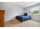 Simple bedroom with a twin bed, light gray walls, and ample natural light at 8268 W Caley Pl, Littleton, CO 80123
