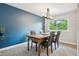 Bright dining room with elegant lighting and large window overlooking the yard at 8268 W Caley Pl, Littleton, CO 80123