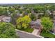 A well-maintained house with a green lawn and mature trees at 8268 W Caley Pl, Littleton, CO 80123