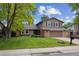 Traditional two-story home with manicured front yard and brick detailing at 8268 W Caley Pl, Littleton, CO 80123