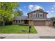 Charming two-story home with well-manicured lawn and attached two-car garage at 8268 W Caley Pl, Littleton, CO 80123