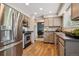 Kitchen area with stainless steel appliances, including fridge, oven and dishwasher at 8268 W Caley Pl, Littleton, CO 80123