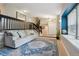 Comfortable living area with wooden floors, gray couch and black-railed stairway to the second floor at 8268 W Caley Pl, Littleton, CO 80123