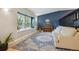 Inviting living space showcasing light hardwood floors, piano, and decor accents at 8268 W Caley Pl, Littleton, CO 80123