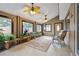 Bright sun room featuring many windows, plants, and an easel at 8268 W Caley Pl, Littleton, CO 80123