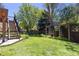 Grassy backyard includes a wooden structure and plenty of room at 1774 Spring Water Pl, Highlands Ranch, CO 80129