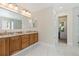 Bright bathroom boasts a dual-sink vanity with marble countertops and flooring at 1774 Spring Water Pl, Highlands Ranch, CO 80129