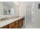 Well lit bathroom features double sinks, granite counters, wood cabinets, and entry to shower and tub at 1774 Spring Water Pl, Highlands Ranch, CO 80129