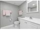 Bathroom features a gray accent wall, vanity, and a decorative mirror at 1774 Spring Water Pl, Highlands Ranch, CO 80129