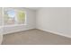 Bright bedroom features a large window and neutral carpeting at 1774 Spring Water Pl, Highlands Ranch, CO 80129