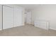 Empty bedroom featuring white walls, closet with sliding doors, and light-colored carpet at 1774 Spring Water Pl, Highlands Ranch, CO 80129