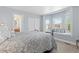 Cozy bedroom with window seat, bay window, and a connecting bathroom at 1774 Spring Water Pl, Highlands Ranch, CO 80129