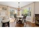 Cozy dining area featuring a chandelier and a sliding glass door to the outside patio area at 1774 Spring Water Pl, Highlands Ranch, CO 80129