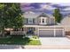 Charming two-story home with a three-car garage, well-manicured lawn, and welcoming front porch at 1774 Spring Water Pl, Highlands Ranch, CO 80129