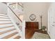 Spacious foyer with a staircase, dark wood floors, area rug, and elegant furniture at 1774 Spring Water Pl, Highlands Ranch, CO 80129